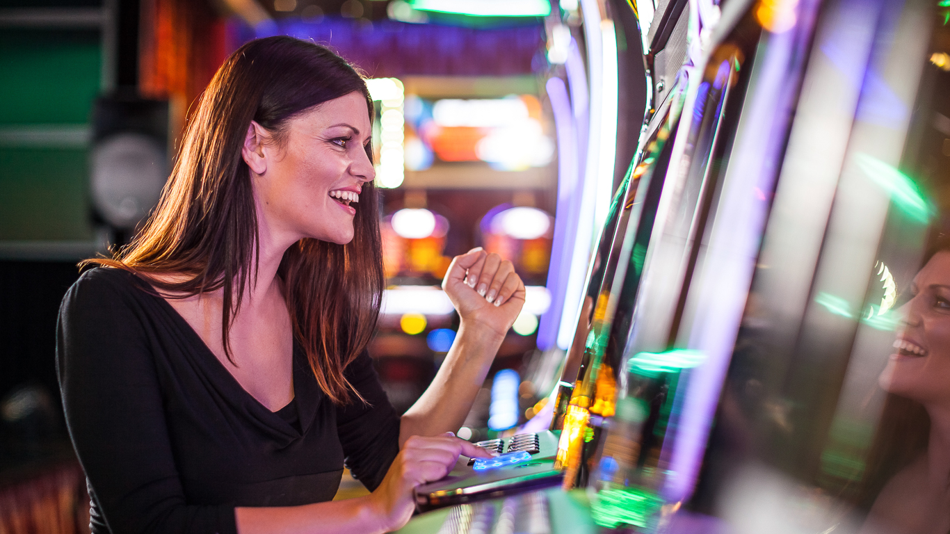 Young woman playing slot machines at the Casino